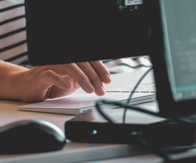 A person typing at a keyboard